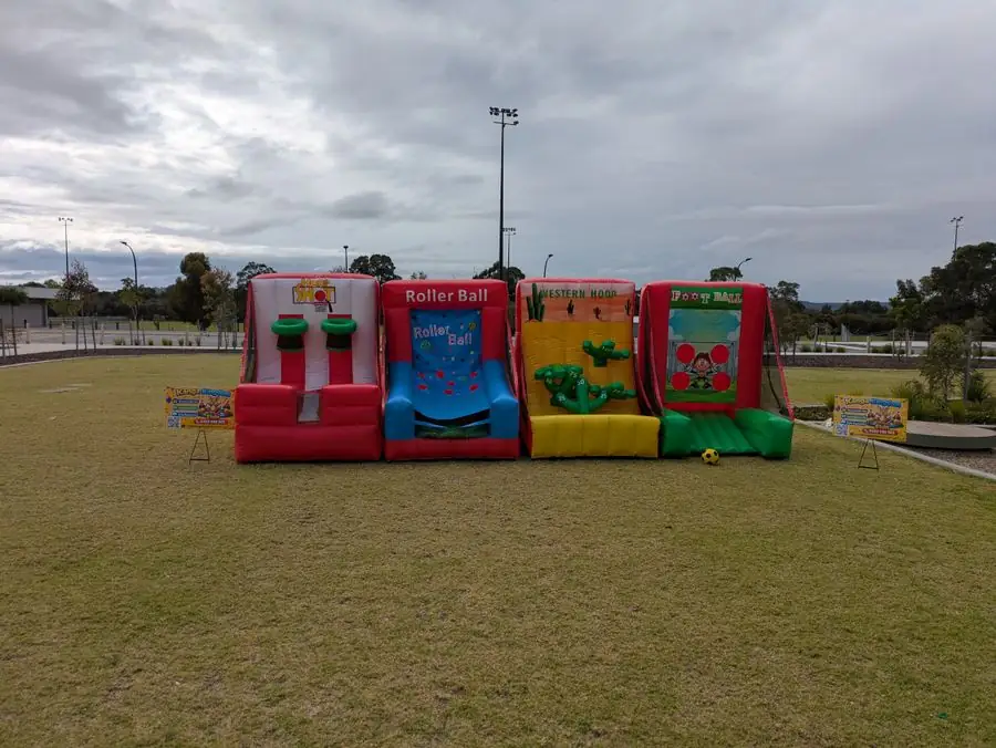 All four inflatable carnival games lined up on a sports oval in Perth